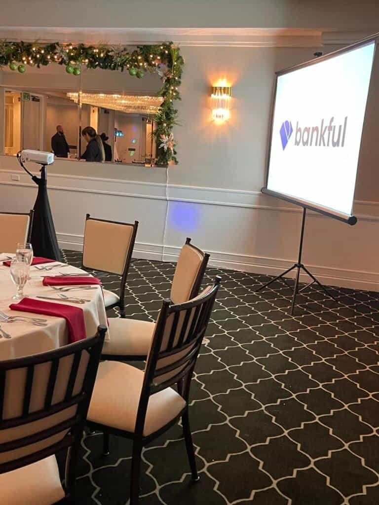 Corporate holiday party with the company logo on a projector screen