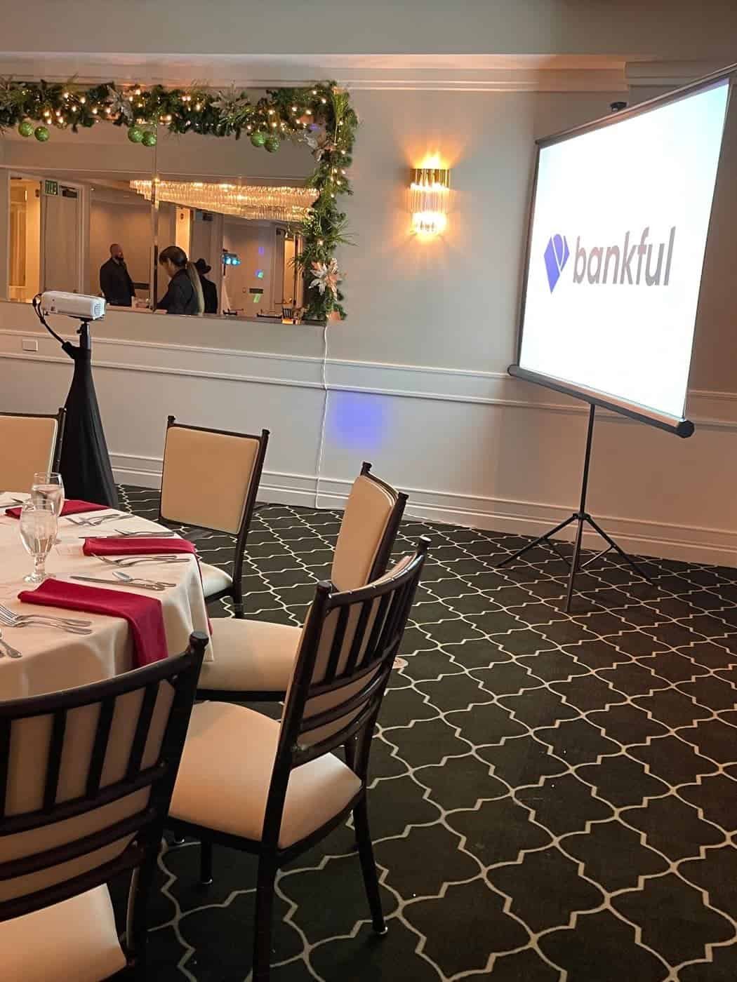 Corporate holiday party with the company logo on a projector screen