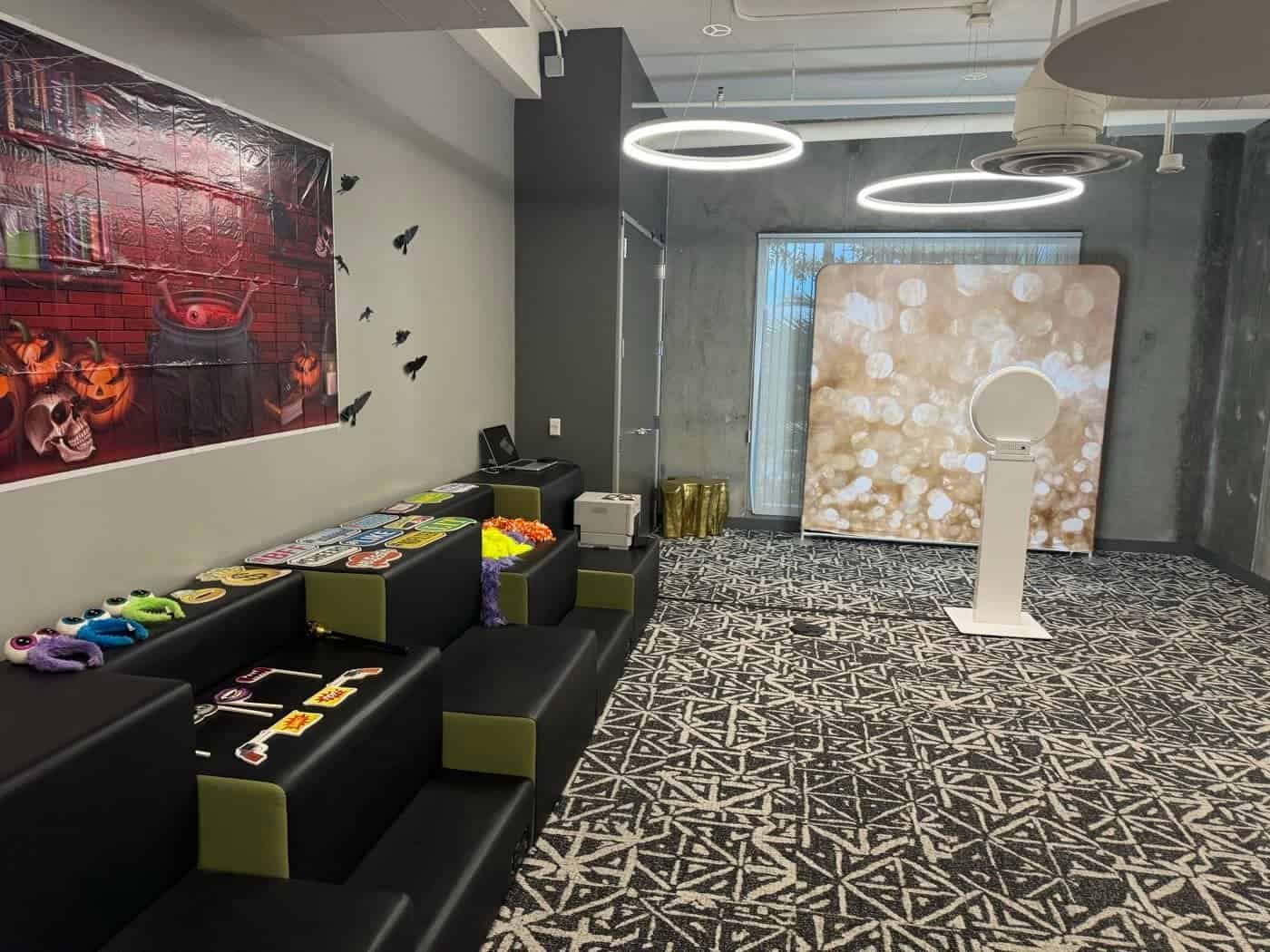 Selfie photo booth with backdrop and props set up in an office