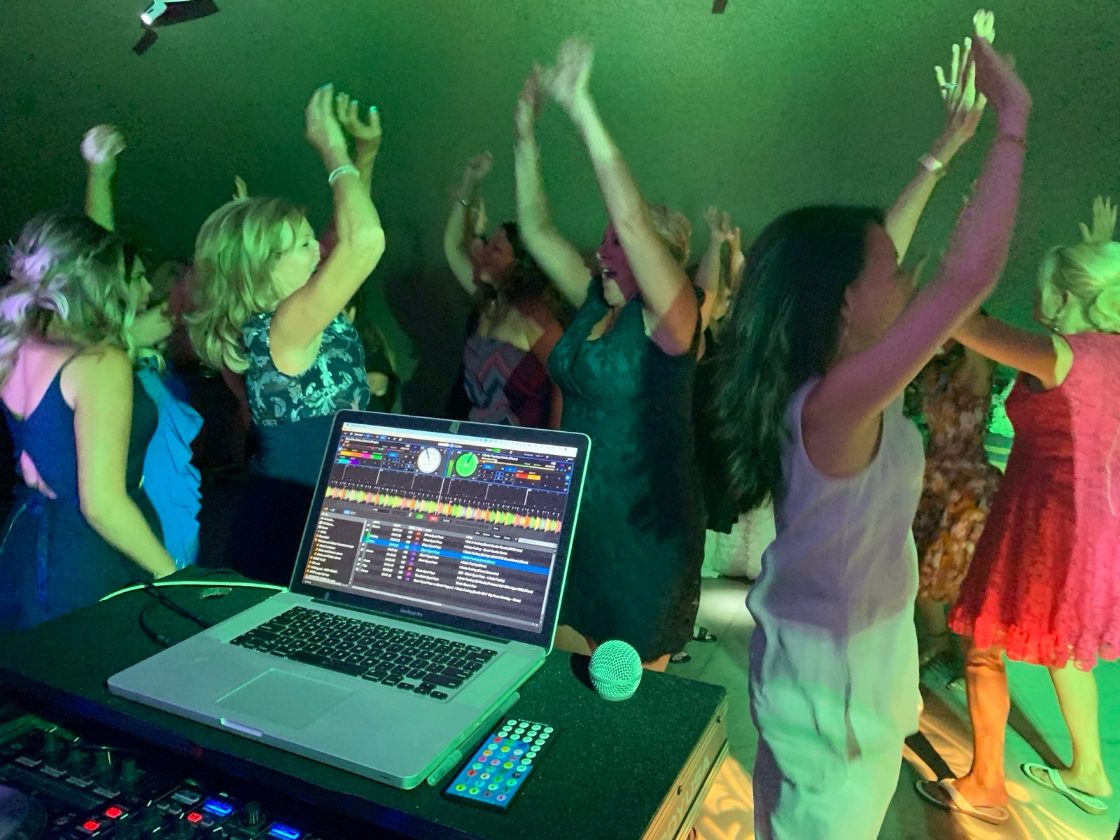 Guests dancing with hands up at a party