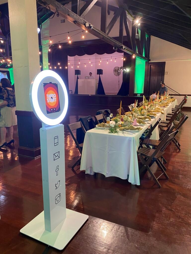Selfie photo booth in a reception hall beside the dinner tables