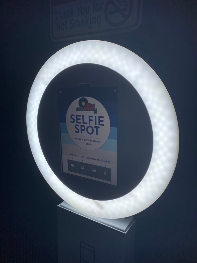 Selfie Spot photo booth ring light glowing at night